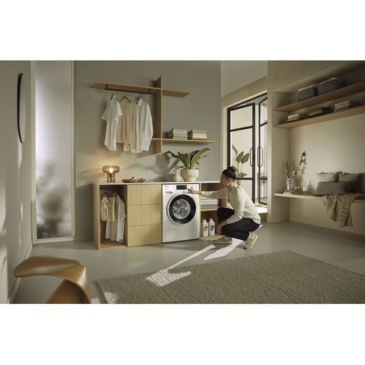 Miele W1 WSK363 WCS 10kg Washing Machine with 1400 rpm - White - Washing machine in utility room women doing washing  shot